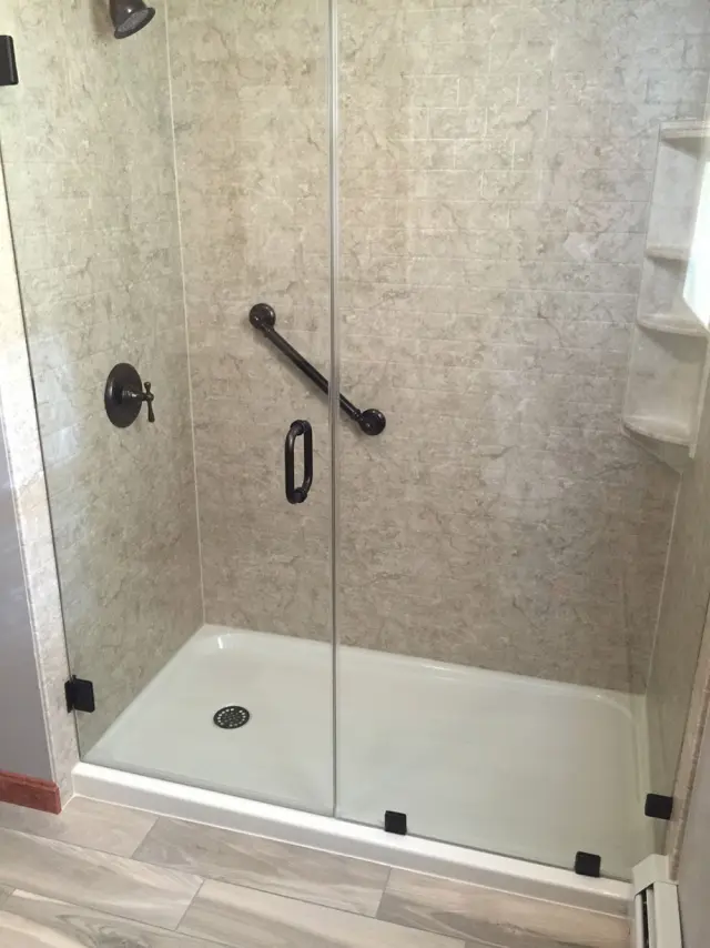 Low-threshold shower with custom glass door in Pembroke